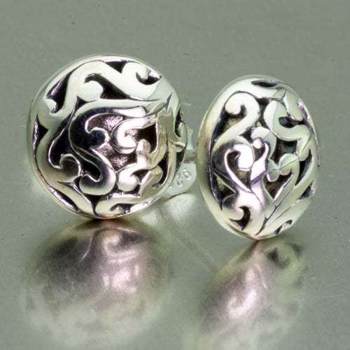 Small, round sterling silver ajoure stud earrings.