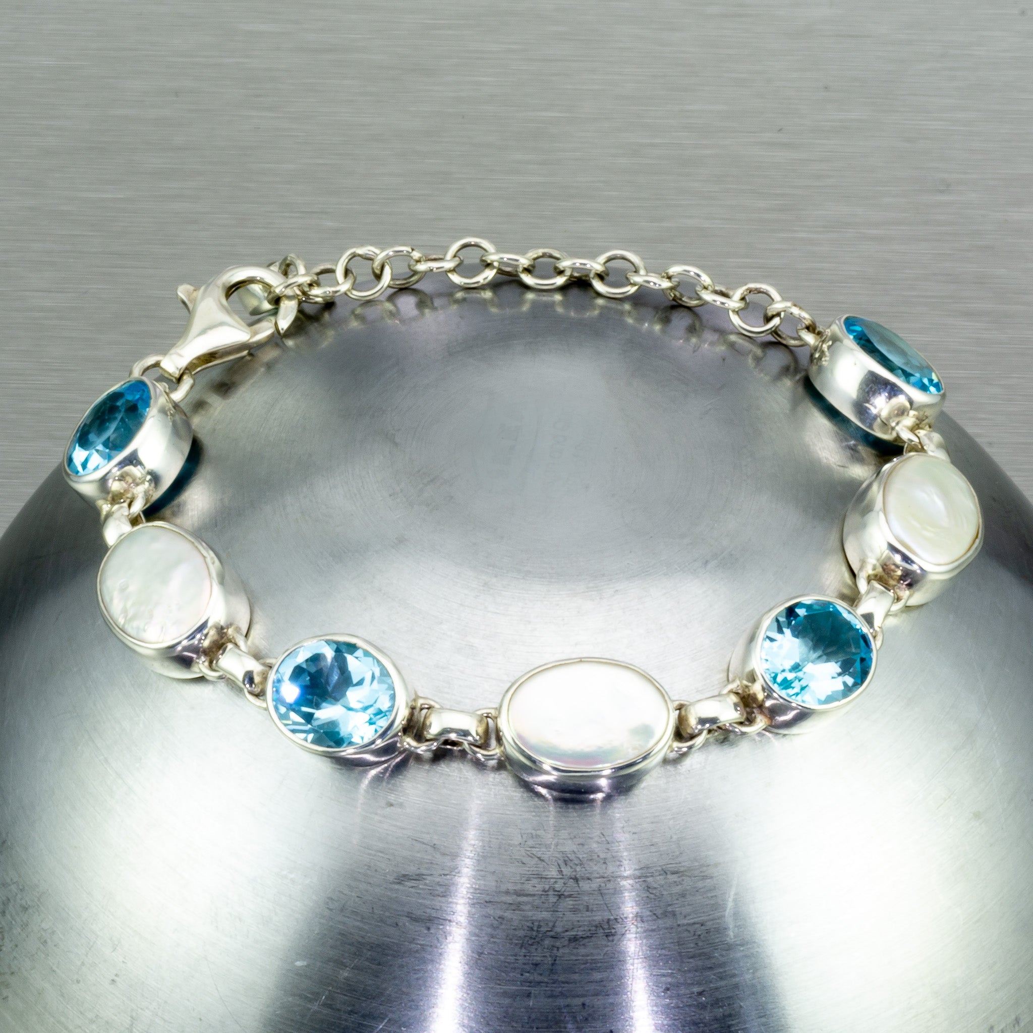 Blue topaz and baroque pearl sterling silver bracelet.