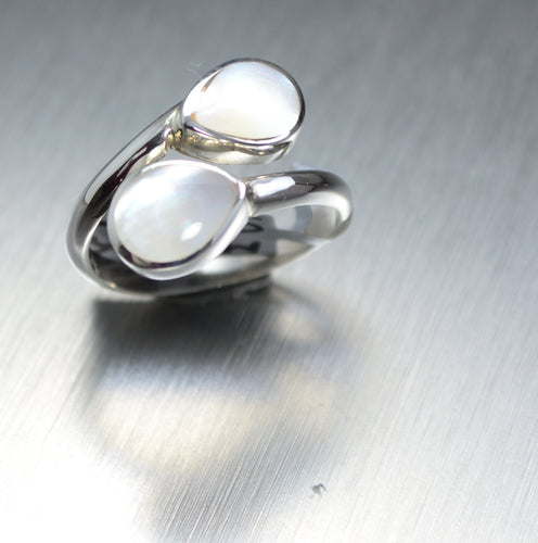 Two teardrops of Mother of Pearl  wrapping around your finger in sterling silver