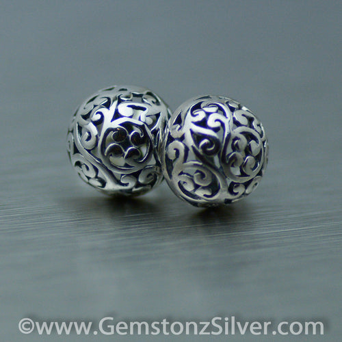 Sterling silver filigree stud dome earrings.