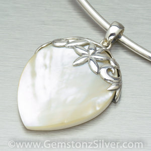 Large mother of pearl pendant with silver ajoure cap