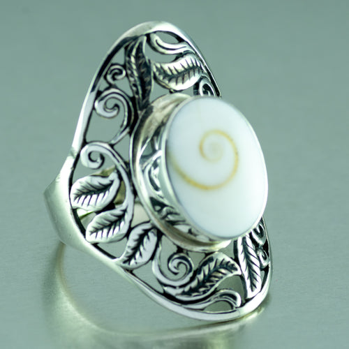 Long shiva shell silver ring with open filigree setting.