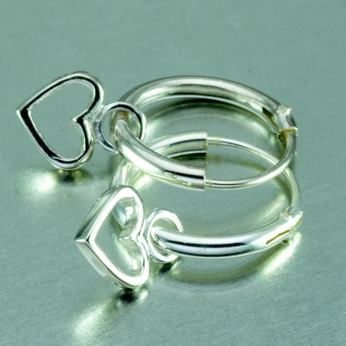 Small silver hoop earrings with tiny dangly heart.