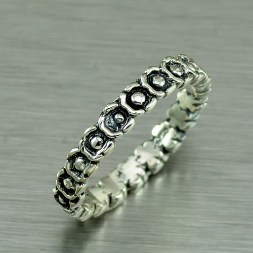 Sterling silver eternity ring of tiny flowers.